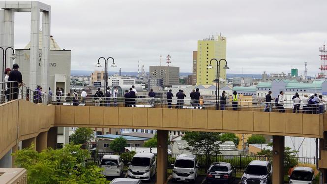 People take shelter at a temporary evacuation site in Kushiro, Hokkaido, northern Japan Wednesday, July 30, 2025 after a powerful earthquake in Russia's Far East prompted tsunami alert in parts of Japan. (Kyodo News via AP)  TKMY807
