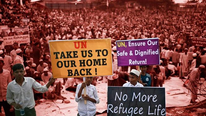 Nästan 400 miljoner människor har tvingats fly sina hem de senaste tio åren på grund av klimatkris, oroligheter och väpnade konflikter. Här ses barn ur folkgruppen rohingya i ett flyktingläger i Bangladesh vädja om hjälp till FN.