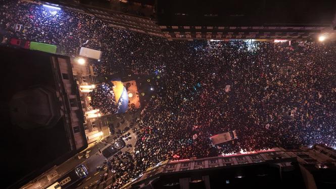An aerial view shows Bosnia players, left, greeting fans after the Bosnian national team qualified for the World Cup by winning a penalty shootout against Italy, in Sarajevo, Bosnia, Wednesday, April 1, 2026. (AP Photo/Armin Durgut)  XAD103